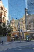 Reflection of old city hall in high rise.