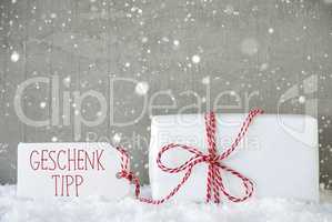 Cement Background With Snowflakes, Geschenk Tipp Means Gift Tip