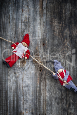 two little rag dolls hanging from a rope