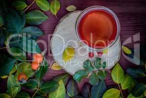 Tea with fruits on a wooden surface, vintage toning