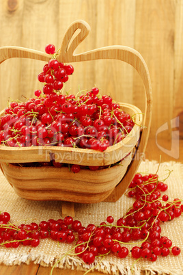 berries of red currant on the wooden vase