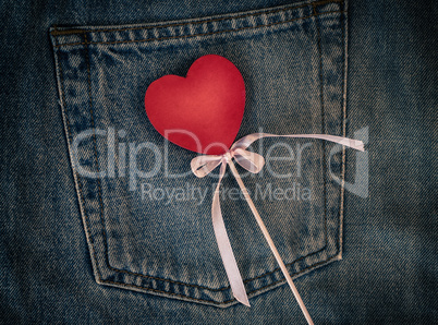 Wooden figure of heart on the background of the back pocket of b