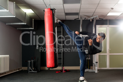 At gym. Photo of boxer training his kick