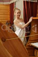 In spa. Pretty woman posing with cedar hot tub