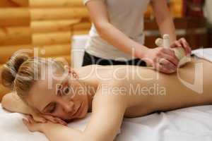 In spa. Girl relaxes during massage with salt bags