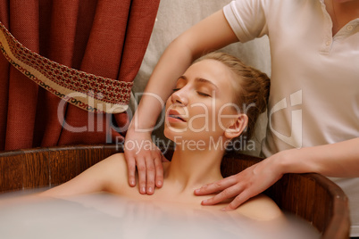 Girl's shoulders massaged during she taking bath