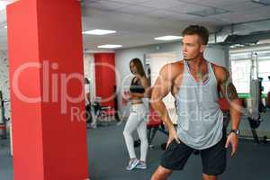 Photo of handsome muscular athlete posing in gym