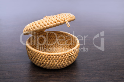 Studio photo of small wicker basket with lid
