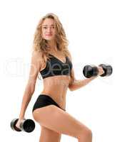 Pretty girl posing while exercising with dumbbells
