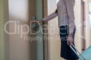 Woman opens door to room using electronic key