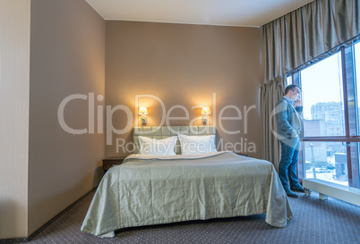 Businessman talking on cell phone in hotel room