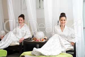 Image of smiling girls relaxing in spa salon