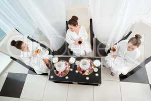 Top view of pretty girls drinking tea in spa salon