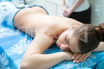 Spa massage. Young girl lying on her stomach