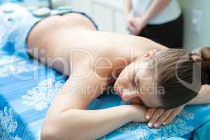 Spa massage. Young girl lying on her stomach