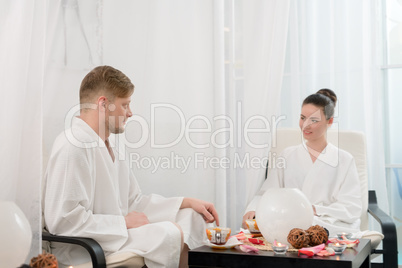 Attractive man and woman relaxing in spa salon