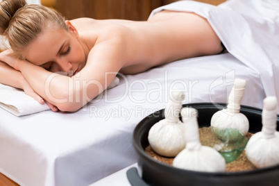 Thai massage with salt bags. Girl posing lying