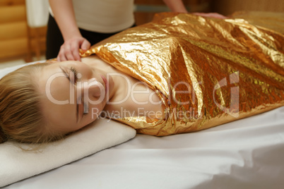 Caring about beauty. Body wraps in spa salon