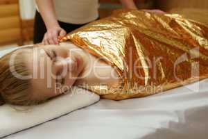 Caring about beauty. Body wraps in spa salon