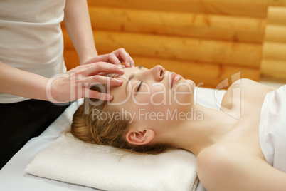 Caring about beauty. Facial massage in spa salon