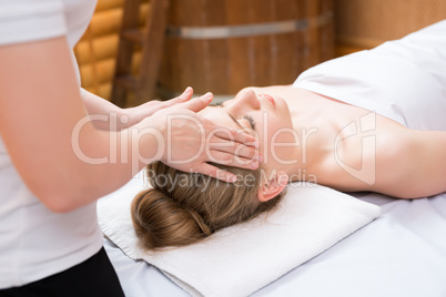 Spa. Masseuse put her hands on girl's face