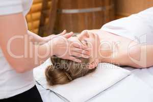 Spa. Masseuse put her hands on girl's face