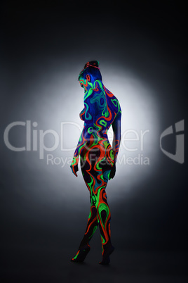 Body art. Nude girl posing with her back to camera