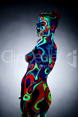 Body art. Portrait of nude girl posing in UV light