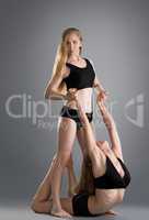 Fitness. Image of blonde helps girl to stretching