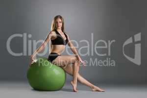 Beautiful girl posing in training on fitness ball