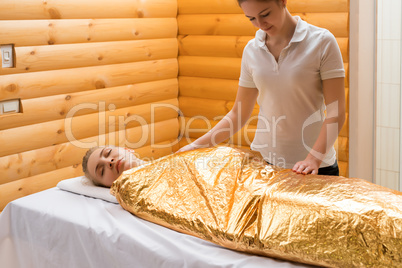 Body wraps. Photo of girl relaxing in spa salon
