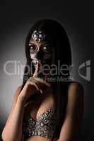 Santa Muerte. Beautiful girl doing silence gesture