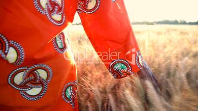 African Woman in Field of Crops at Sunset or Sunrise