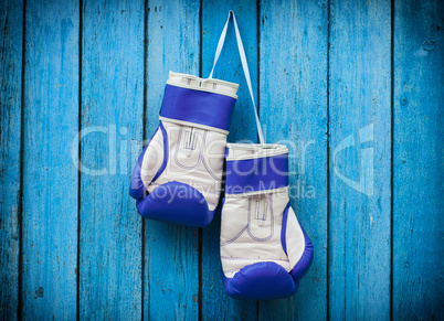 pair of boxing gloves hanging on a nail