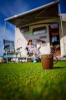 Coffee Mug on grass. Family vacation travel, holiday trip in mot