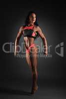 Bodybuilding. Woman posing showing her muscles
