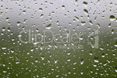 Raindrops flow on the window glass