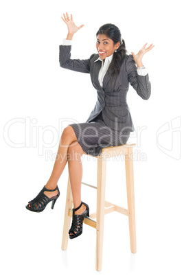 Happy black businesswoman seated on chair.