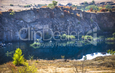 deep unused stone quarry and the river