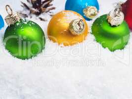Christmas baubles in snow