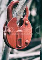 Red  lock on a white fence