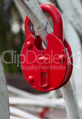 Red iron lock on a white fence