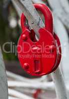 Red iron lock on a white fence