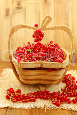 berries of red currant on the wooden vase