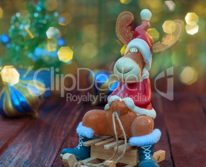 Reindeer on winter wooden sled, blurred bokeh background with mu