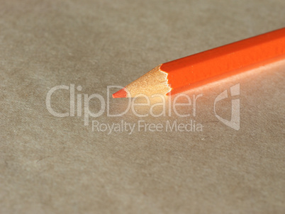 Orange pencil over paper