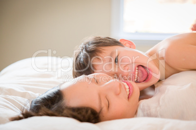 Mixed Race Chinese and Caucasian Boy Laying In His Bed with His