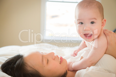 Mixed Race Chinese and Caucasian Baby Boy Laying In Bed with His