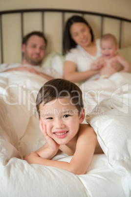 Mixed Race Chinese and Caucasian Boy Laying In Bed with His Fath