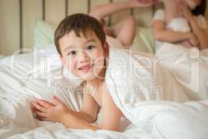 Mixed Race Chinese and Caucasian Boy Laying In Bed with His Fath